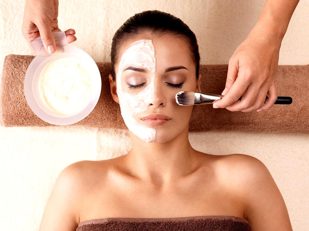 Esthetician applying a calming gel mask around the eyes